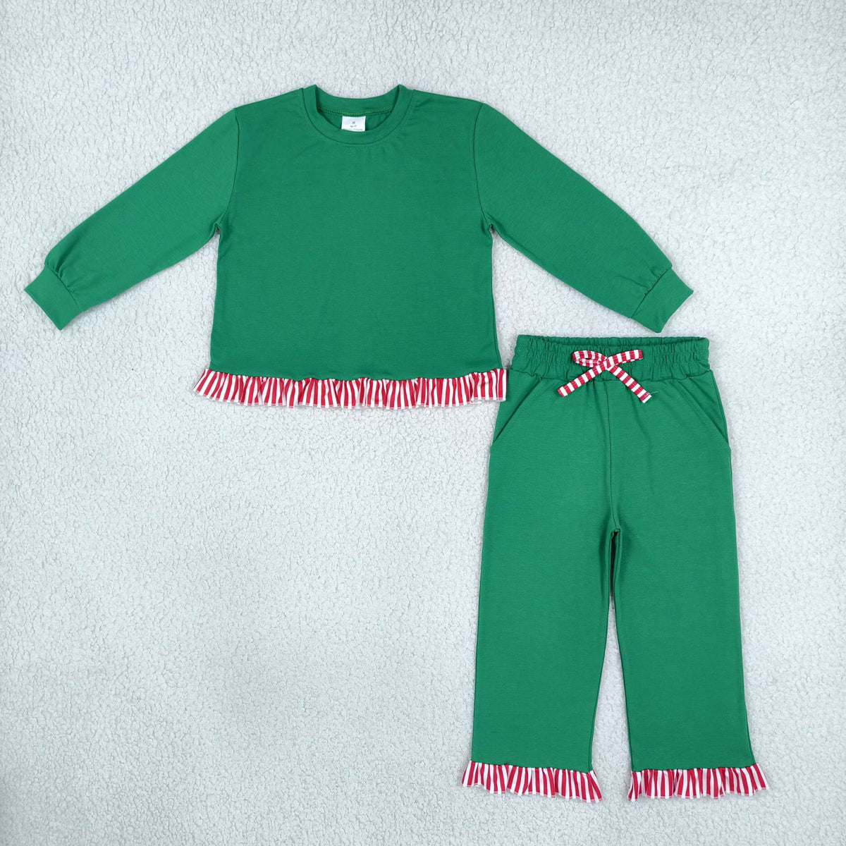 solid green outfit with ruffle red stripe trim