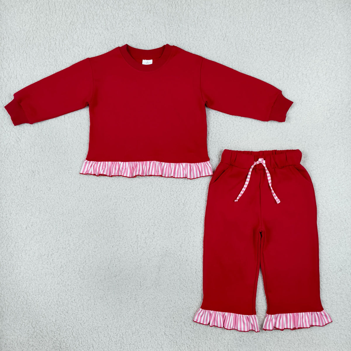 solid red outfit with ruffle striped trim