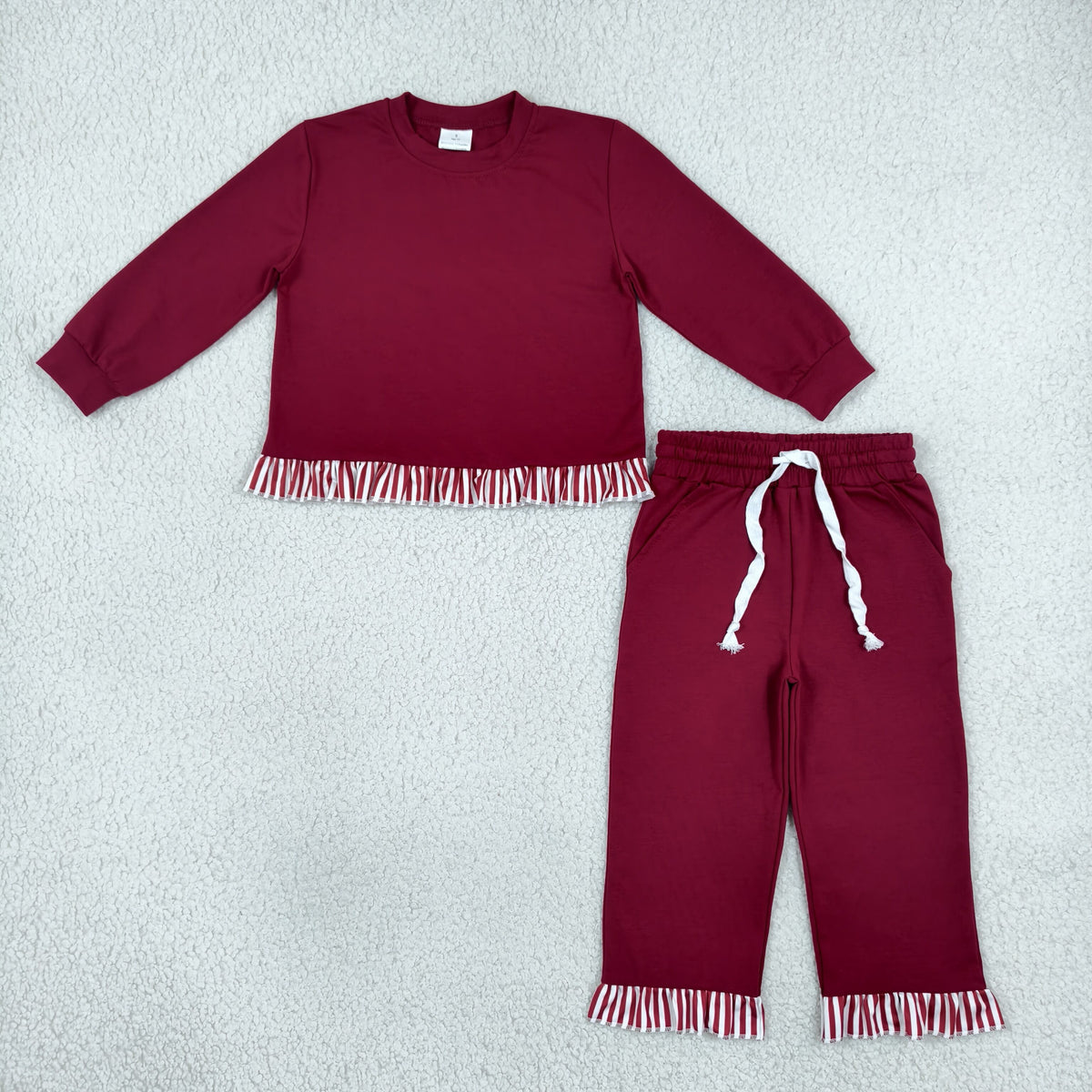 solid maroon outfit with ruffle striped trim
